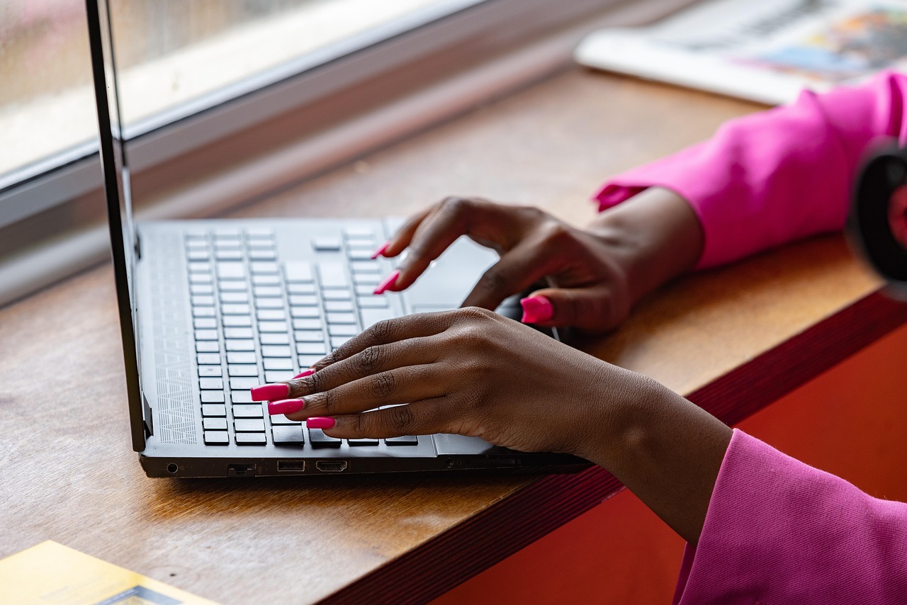 Typing hands on a laptop.